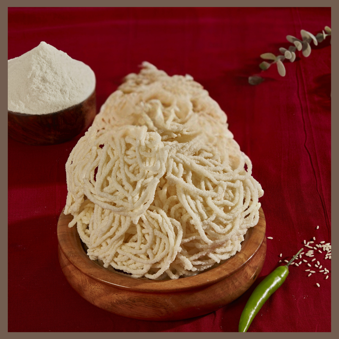 Malu's crispy Ompodi Vadam 250g arranged on wooden plate with flour and green chili on red cloth