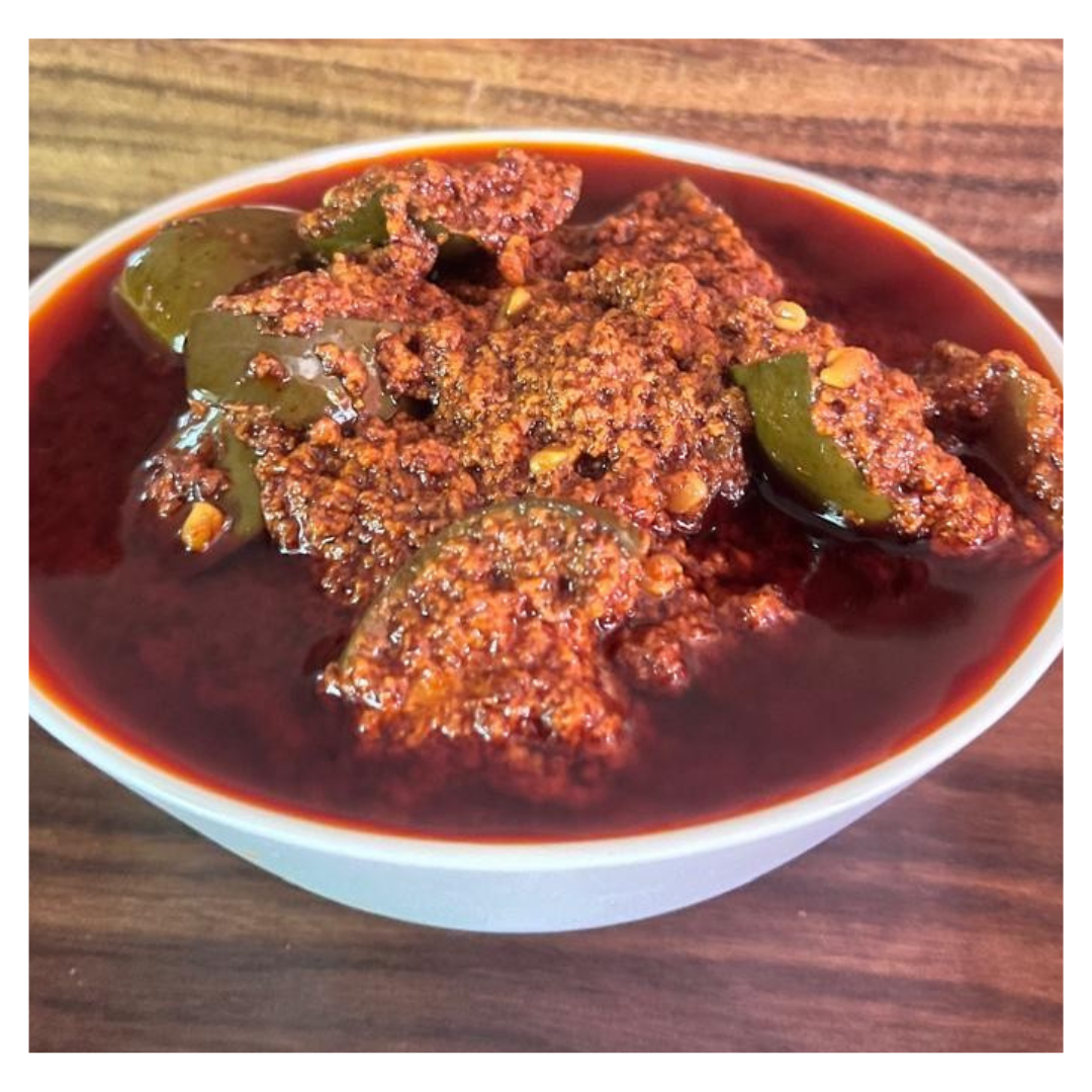 Malu's spicy homemade Avakkai pickle in a white bowl ready to buy Avakkai pickle online