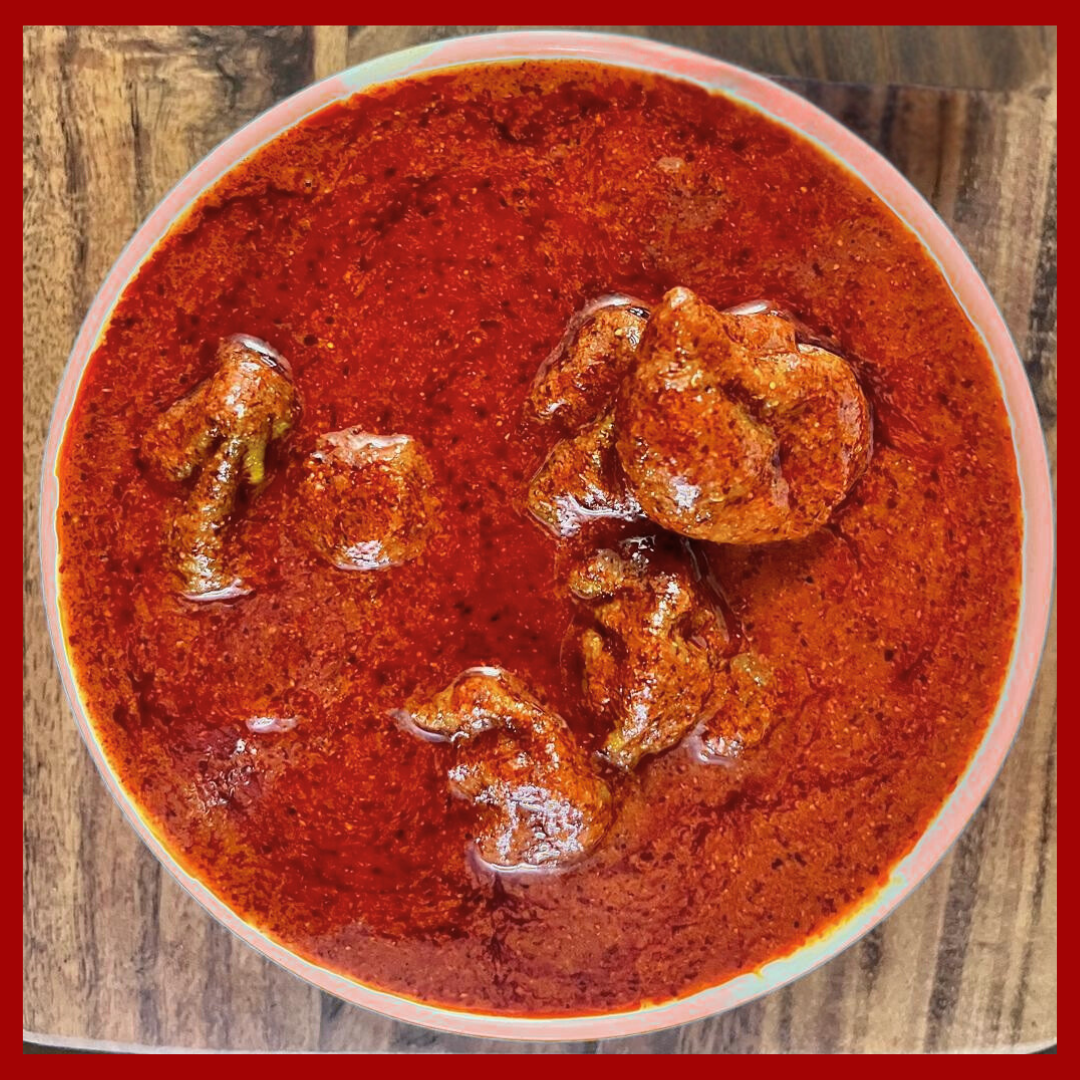 Spicy red Maavadu fish pickle in a bowl ready to buy Maavadu online from Malu's