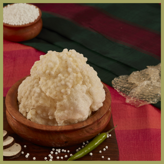 Malu's crispy Javarasi Vadam 250g served in a wooden bowl with green chili and sago pearls on a red and green cloth