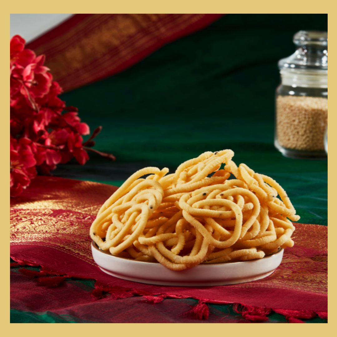 Malu's traditional Thenkuzhal 180g crispy snack served on white plate with decorative background